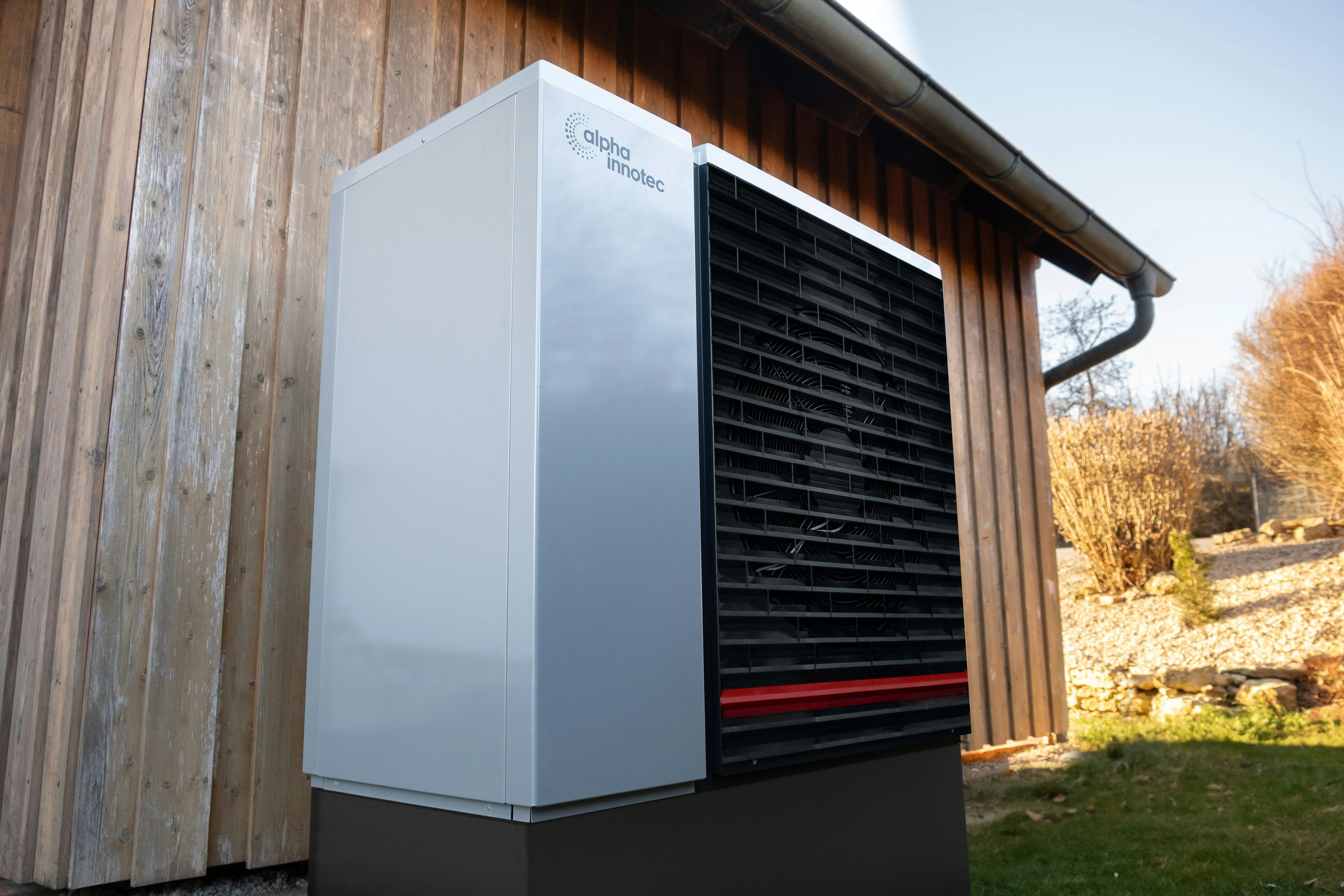 Air source heat pump installed on the external wall of a UK home